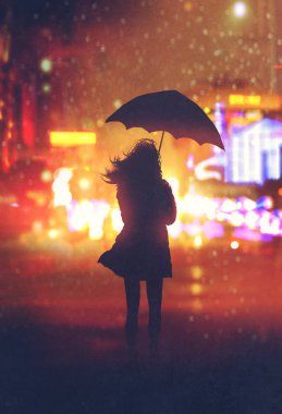 gece şehirde şemsiye ile yalnız kadın