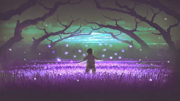 Boy standing in the garden of purple flowers — Stock Photo, Image