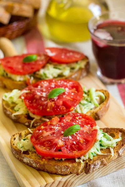 Bruschetta topped with cucumber salad and tomato — Stock Photo, Image