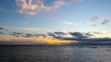 Dumaguete şehirden bir renkli gündoğumu video, Negros oryantal, Türkiye kıyıları. Cumulus bulutları çekimde ince dalgalar üzerinde görülebilir.