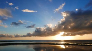 Renkli gündoğumu düşük gelgit sırasında alınan çok düşük cumulus bulutları ile video. Hareketli bulutlar yansıması ise ufuk rising sun gelgit tarafından geride havuzları görülebilir. Hızlı hareket (uzun pozlama süresi sunulan