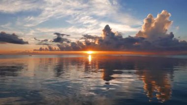 Bir çok renkli gündoğumu video Dumaguete şehir shores okyanus gibi ayna ile üzerinden. Güneş ufuk üzerinde görülebilir. Bir yavaş hareket sembolleri kamera ile çekim.