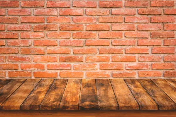 Wood table top on red brick wall — Stock Photo, Image