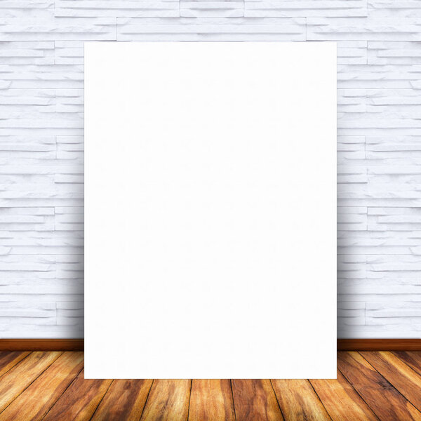 Blank white paper poster lean at brick wall and wood floor. For text input or according to your design.