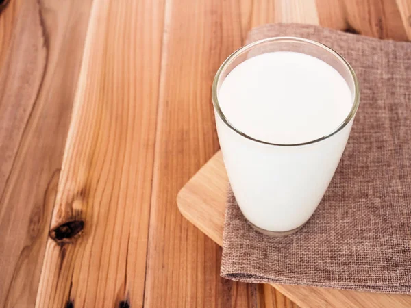 Milk glass on wood table — Stock Photo, Image