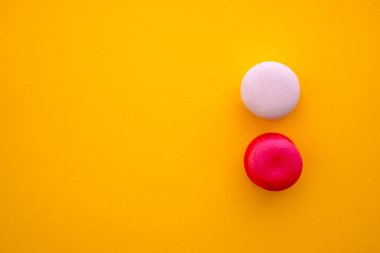 Sarı arkaplanda renkli badem kurabiyeleri