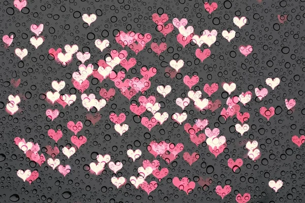 Regnet droppar på glaset med abstrakt hjärta lampor — Stockfoto