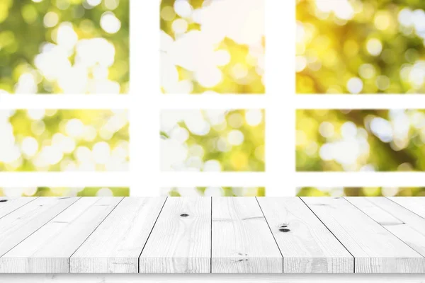 Empty wood table with blur window on green bokeh background. — Stock Photo, Image