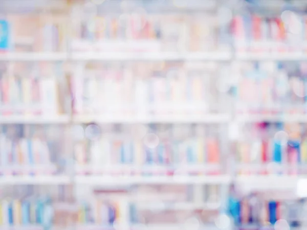 Blurred image of many books on bookshelf in library background. — Stock Photo, Image