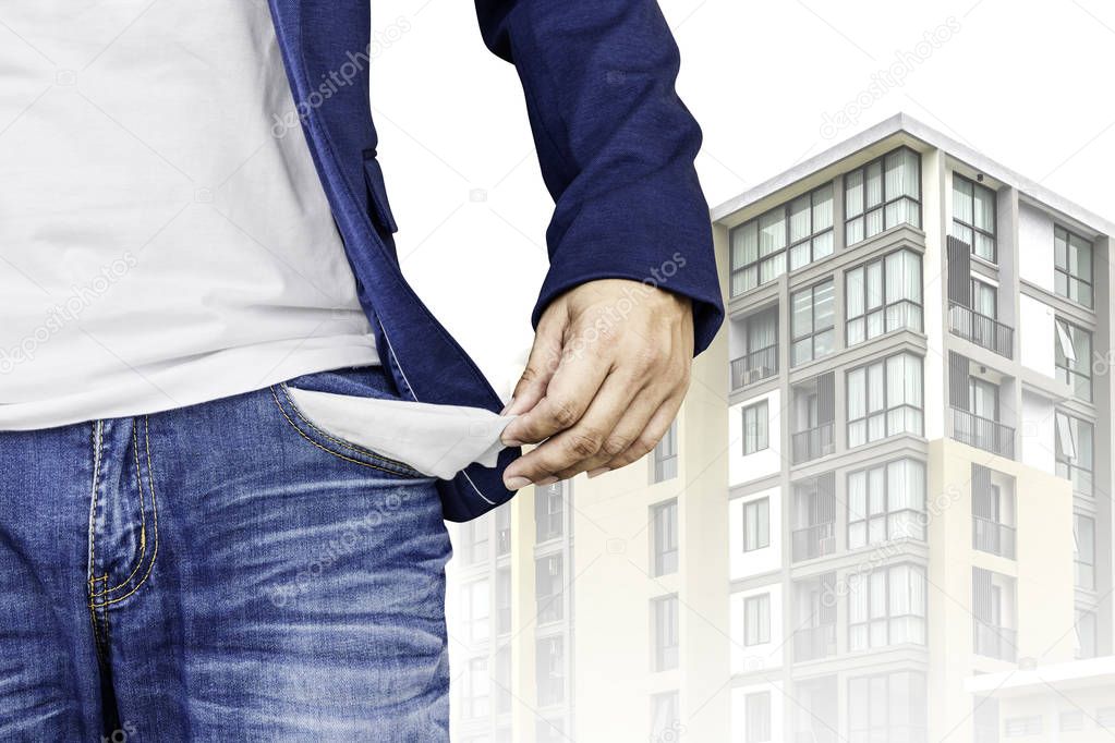 Man showing his empty pocket with condominium background.