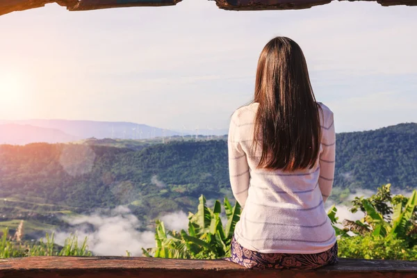 Woman traveler looking sea of mist at Khao Kho, Thailand.