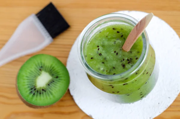 Homemade kiwi fruit beauty mask (scrub) in a glass jar. DIY cosmetics. — Stock Photo, Image