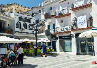 MIJAS, ANDALUSIA/SPAIN - SEPTEMBER 11: Street of Mijas with small restaurants - typical white town in Andalusia, southern Spain, provence Malaga, Costa del Sol. Mijas , Spain on September 11, 2016  clipart