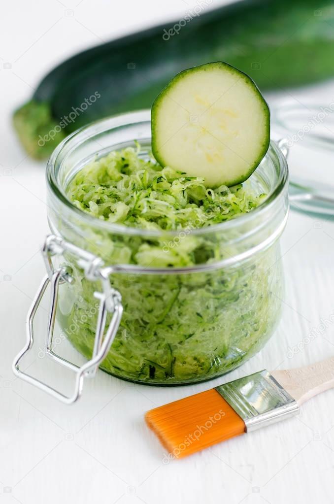 Grated zucchini in a glass jar - natural diy facial mask. Homemade cosmetics and spa. 