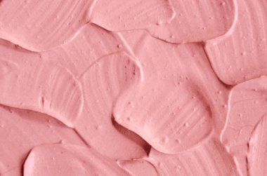 Pembe kozmetik kil (yüz maskesi, krem) doku yakın kadar seçici odak. Arka plan 