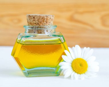 İçinde Roma papatyası esaslı yağ bulunan eski bir şişe (özü, tütsü, zerk). Aromaterapi, spa ve bitkisel tıp konsepti. Boşluğu kopyala. 