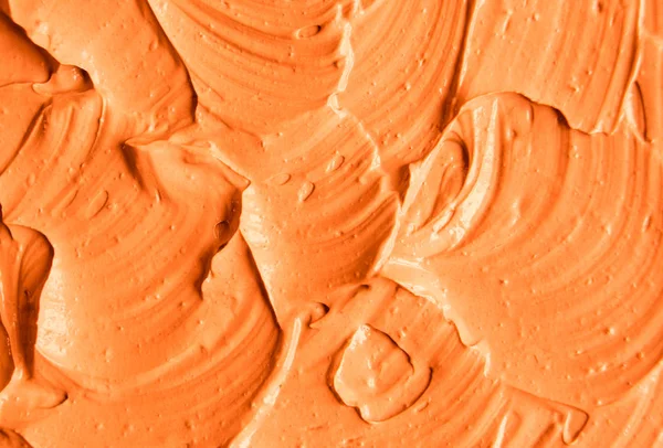 Orangefarbene Gesichtsmaske (Kürbiscreme, Körperpeeling) Textur aus nächster Nähe, selektiver Fokus. abstrakter Hintergrund mit Pinselstrichen. — Stockfoto