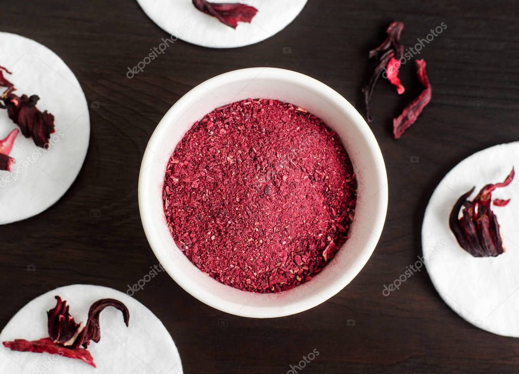 Homemade hibiscus powder for preparing face and body mask or exfoliating scrub (bath salts, foot soak). Karkade DIY beauty treatment and spa recipe. Top view, copy space 