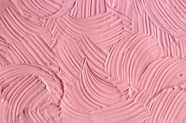 Soft pink cosmetic clay (rhassoul, facial mask, face cream, body wrap, hair shampoo) texture close up, selective focus. Abstract background with brush strokes.