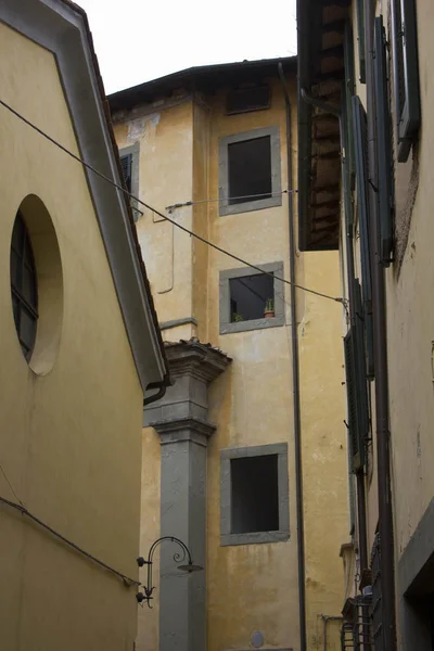 Callejón estrecho a través de edificios históricos en el centro de Lucca — Foto de Stock