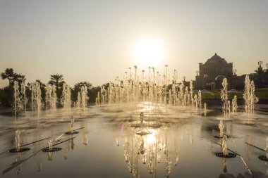 ABU DHABI, UAE - DECEMBER 28 2017: sunset view of the majestic fountains of Emirates Palace