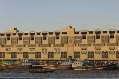DUBAI, UAE - DECEMBER 30 2017: Dubai creek with traditional boats at sunset light