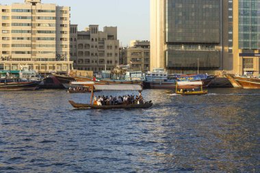 DUBAI, UAE - DECEMBER 30 2017: Dubai creek with traditional boats at sunset light