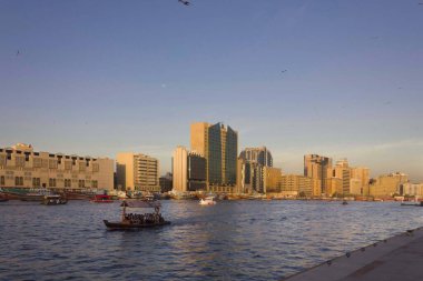DUBAi, UAE - DECEMBER 30 2017: sunset viewof Dubai creek with traditional boat navigation