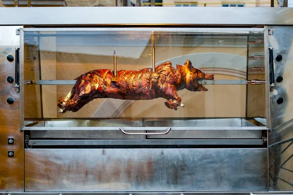 pig whole grilled in an electric oven on the street