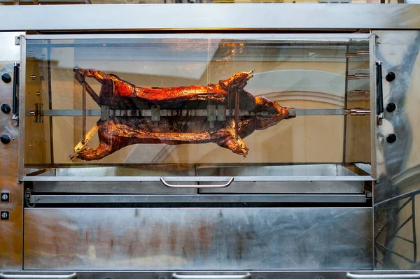 pig whole grilled in an electric oven on the street