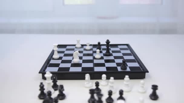 Game of chess. The white pawn defeats the black king. Woman makes a winning move — Stock Video