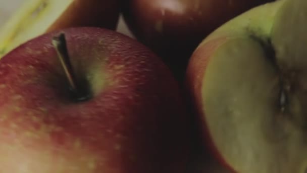 Appels en appelschijfjes met dauwdruppels draaien op een houten plaat — Stockvideo
