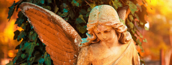 The figure of an angel in a golden glow. Symbol of love, invisib