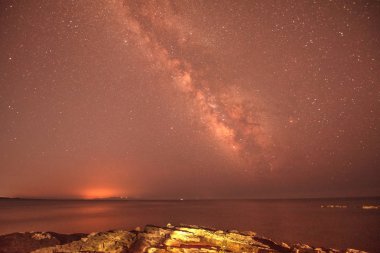 büyülü mistik güzel büyüleyici manzara dalgalar ve yıldızlar ve Samanyolu arka plan karşı kıyısında deniz ortasında taşlar ile. (meditasyon, antistress, gevşeme - kavram)