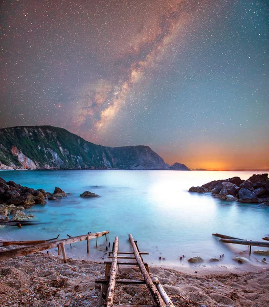 fascinating mystical magical landscape with a Petani Beach and boat racks at night in the light of the Milky Way stars in Kefalonia, Greece. Amazing places. Tourist Attractions.