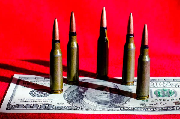 红色背景的100美元钞票上的子弹作为算盘 — 图库照片