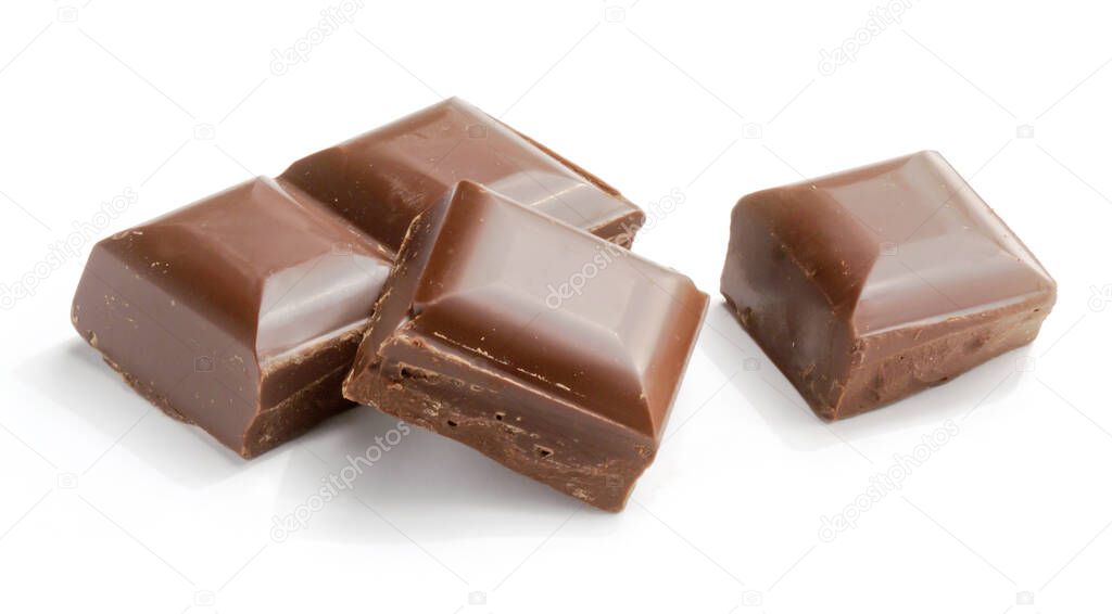 pieces of milk chocolate tablet on white background