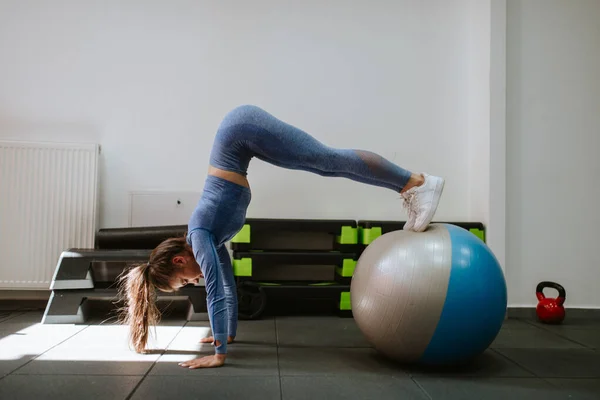 Athletic woman with gym ball