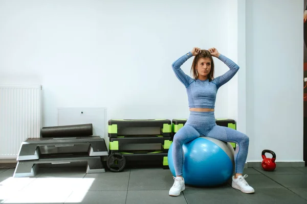 Athletic woman with gym ball