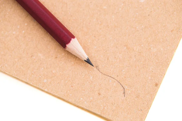 Tužka a notebook izolované na bílém pozadí — Stock fotografie