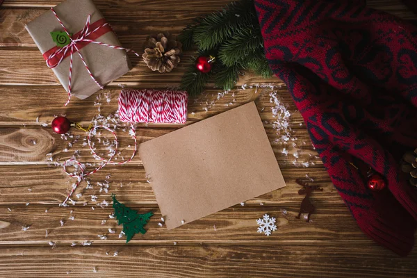 Χριστουγεννιάτικη κάρτα σε φόντο ξύλινη με κλαδιά έλατου Εικόνα Αρχείου