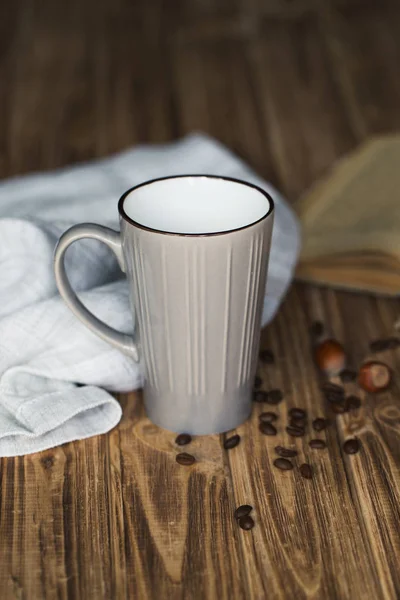 cup of coffee with book in coffee shop vintage color