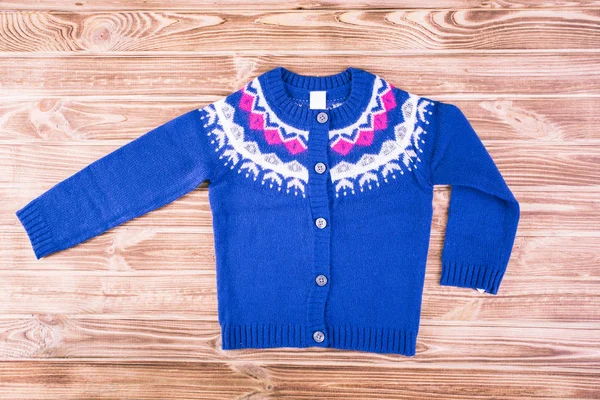 Stylish blue sweater on a children's wooden background — Stock Photo, Image