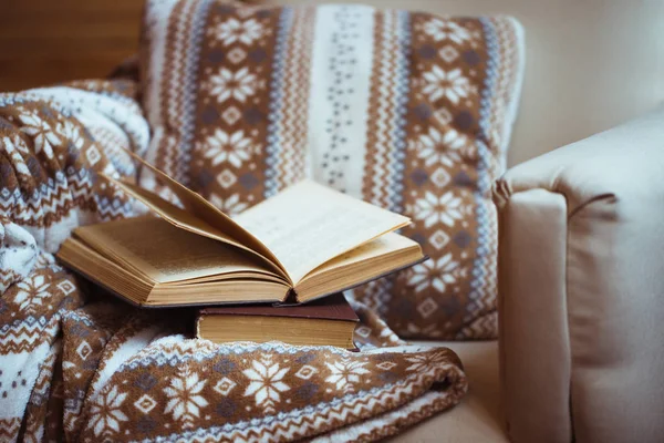 Stack of books with warm plaid on chair — Stock Photo, Image