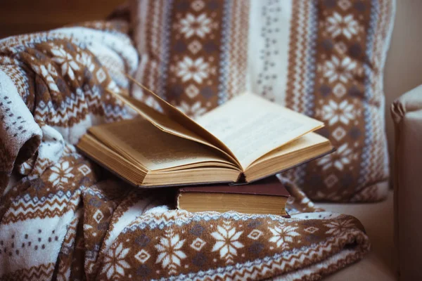 Stack of books with warm plaid on chair — Stock Photo, Image