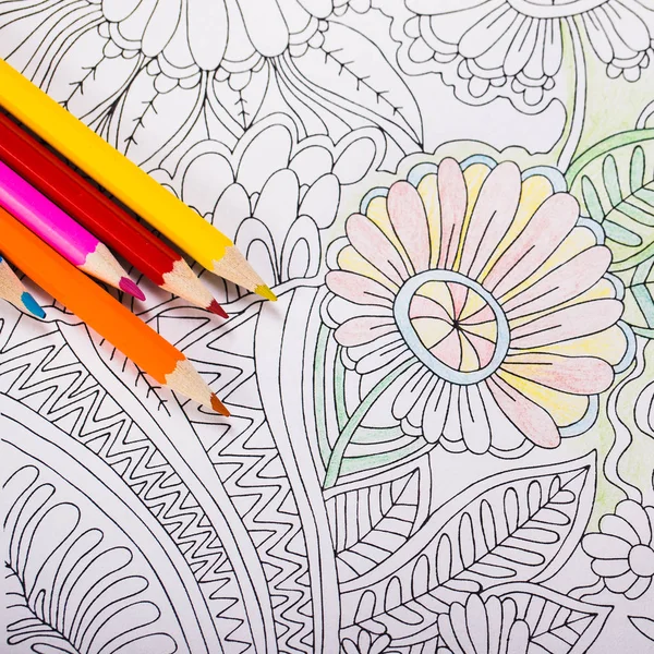 Multi-colored pencils and coloring book for adults — Stock Photo, Image