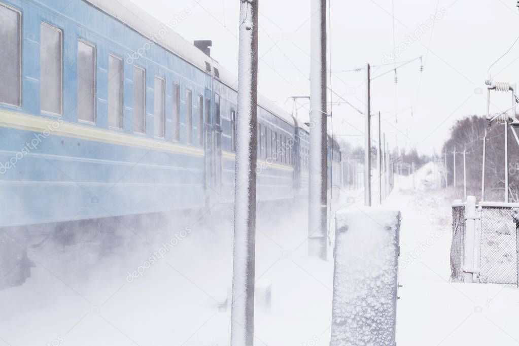 Passenger train rapidly moving along the snow track