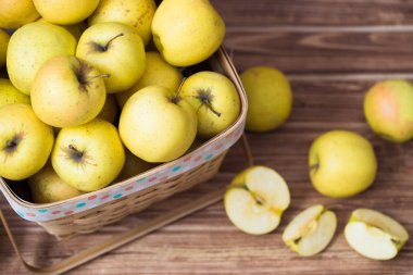 Ahşap arka plan üzerinde bir sepet içinde altın elma