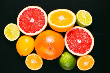 Taze narenciye stihli. Limon, limon, greyfurt ve portakal siyah bir zemin üzerine