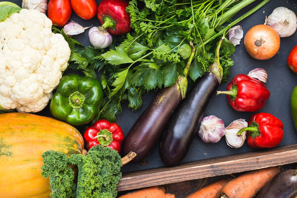 Assortment of fresh vegetables. Carrot garlic peas cabbage onion celery cucumber parsnip and radish concrete board.